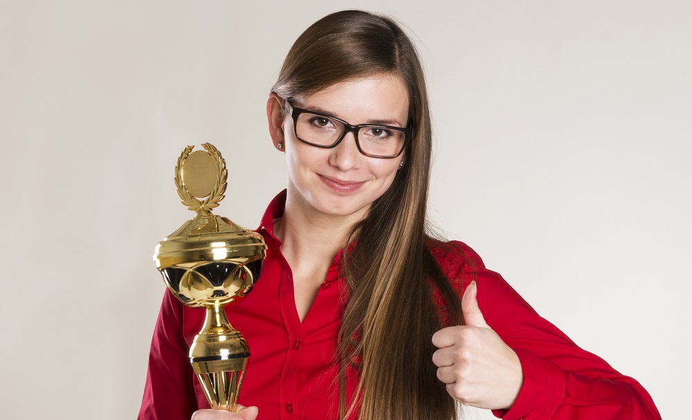 Portrait of successful business woman with trophy.